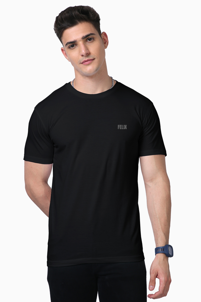 Male model in FELIX black Supima cotton t-shirt with grey reflective vinyl logo on chest – minimalist premium gym and streetwear fashion India