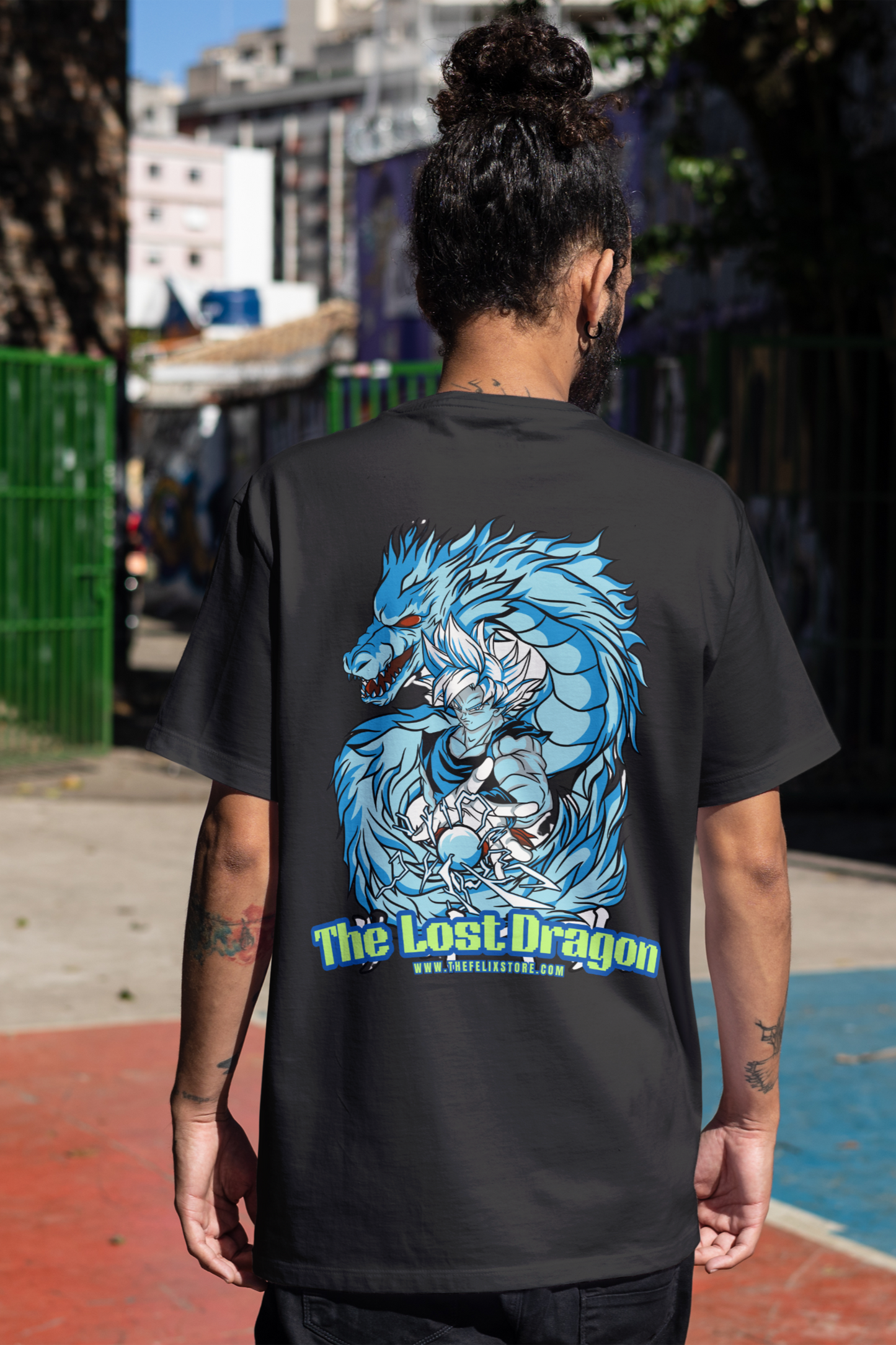 Person wearing a black t-shirt with a blue dragon graphic and 'The Lost Dragon' text on the back, standing outdoors.