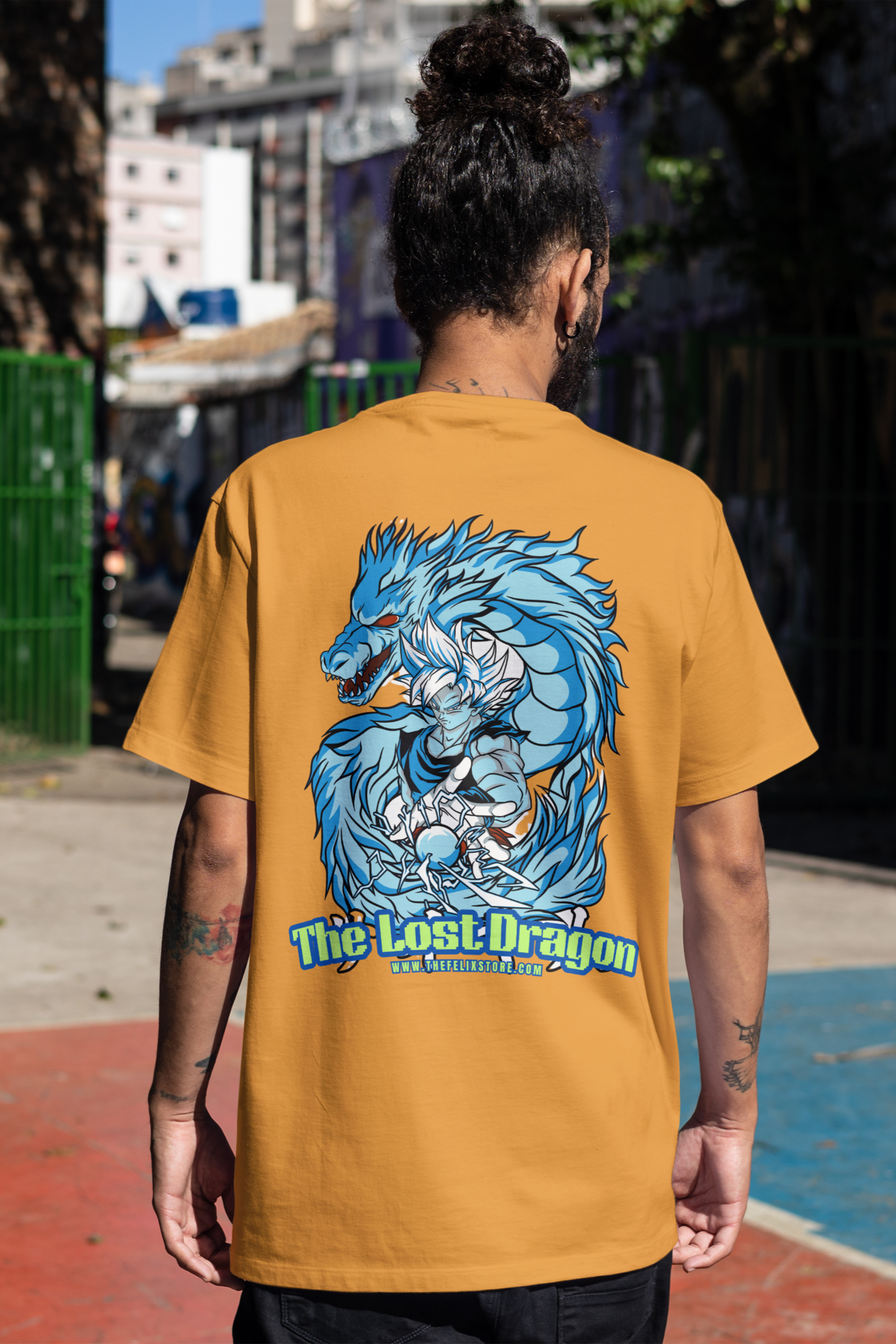 Person wearing a mustard yellow t-shirt with a blue dragon graphic and 'The Lost Dragon' text on the back.