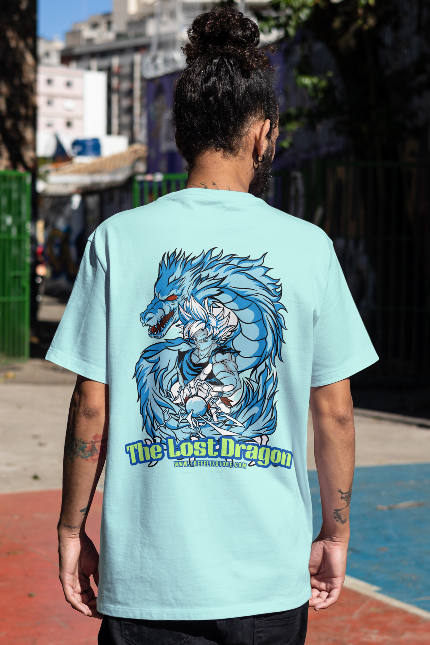 Person wearing a mint t-shirt with a dragon graphic and 'The Lost Dragon' text.