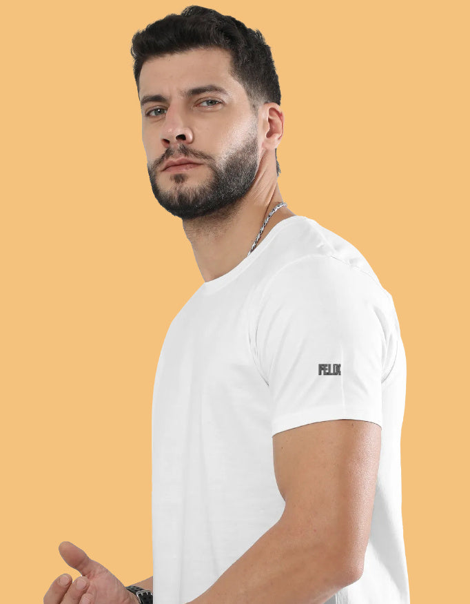 Man wearing a premium crew neck T-shirt with subtle FELIX logo on the sleeve, part of The Felix Store's 9-color plain and melange collection.