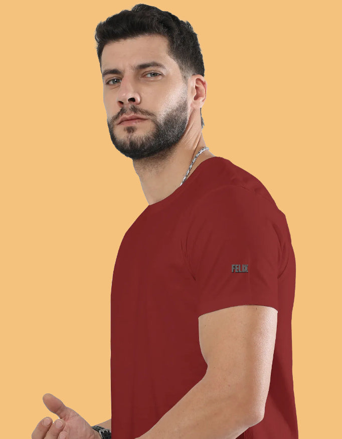 Man wearing a premium crew neck T-shirt with subtle FELIX logo on the sleeve, part of The Felix Store's 9-color plain and melange collection.