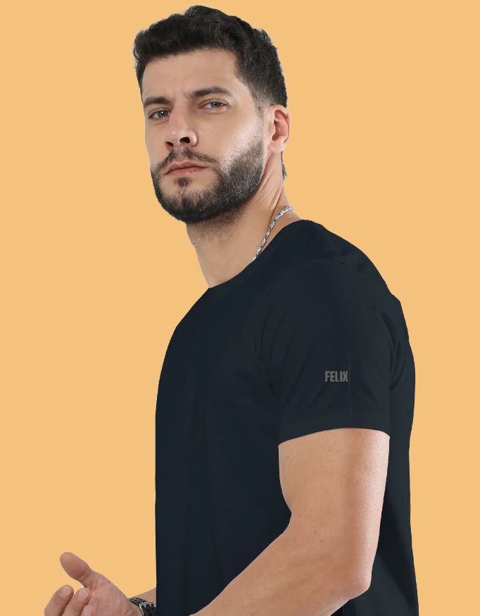 Man wearing a premium crew neck T-shirt with subtle FELIX logo on the sleeve, part of The Felix Store's 9-color plain and melange collection.
