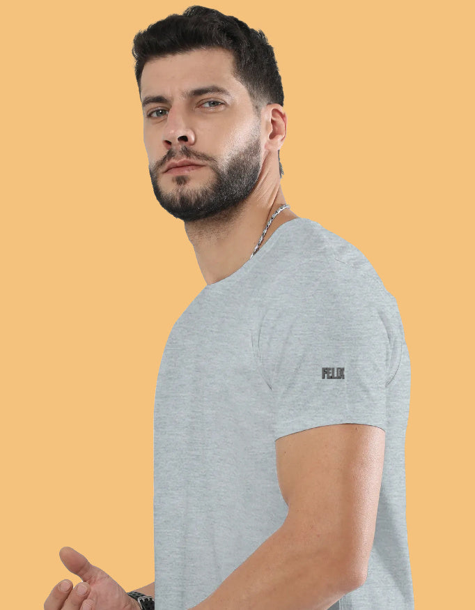 Man wearing a premium crew neck T-shirt with subtle FELIX logo on the sleeve, part of The Felix Store's 9-color plain and melange collection.