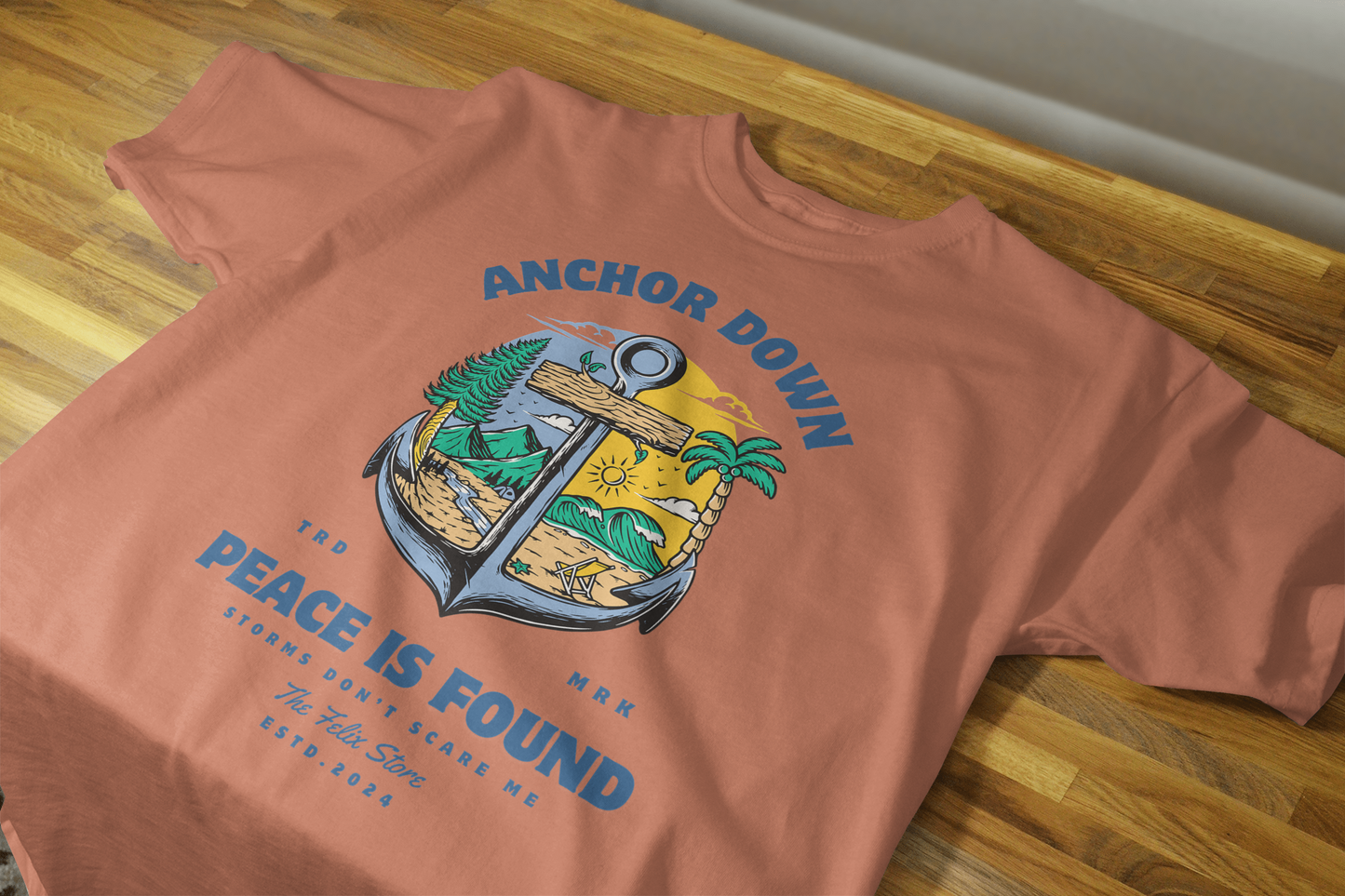"Anchor Down Peace is Found graphic t-shirt by The Felix Store featuring anchor, palm trees, mountains, and sunshine in artistic beach-forest design"