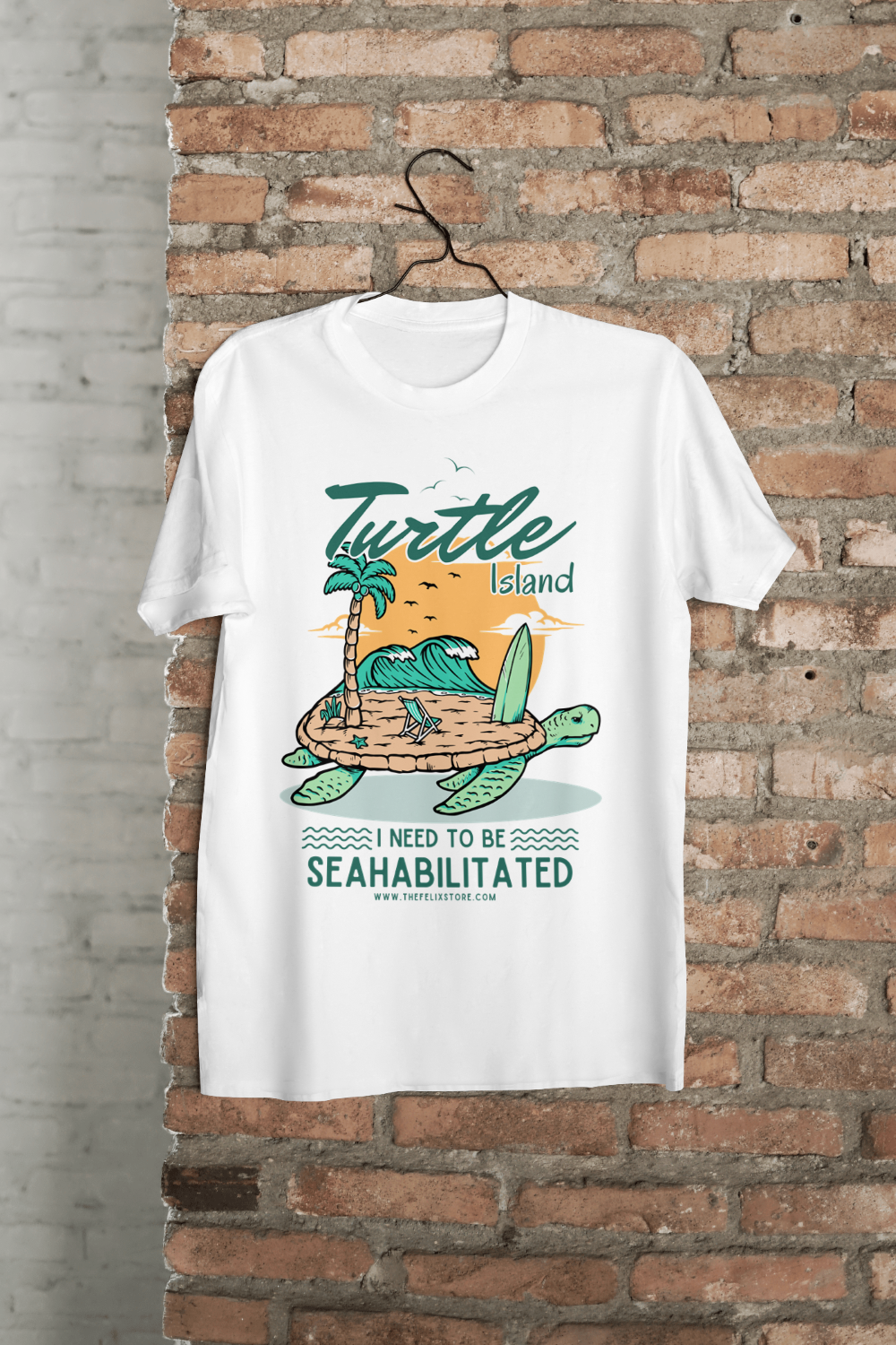 t-shirt featuring a colorful turtle carrying a tropical island with the phrase “I Need to Be Seahabilitated” 