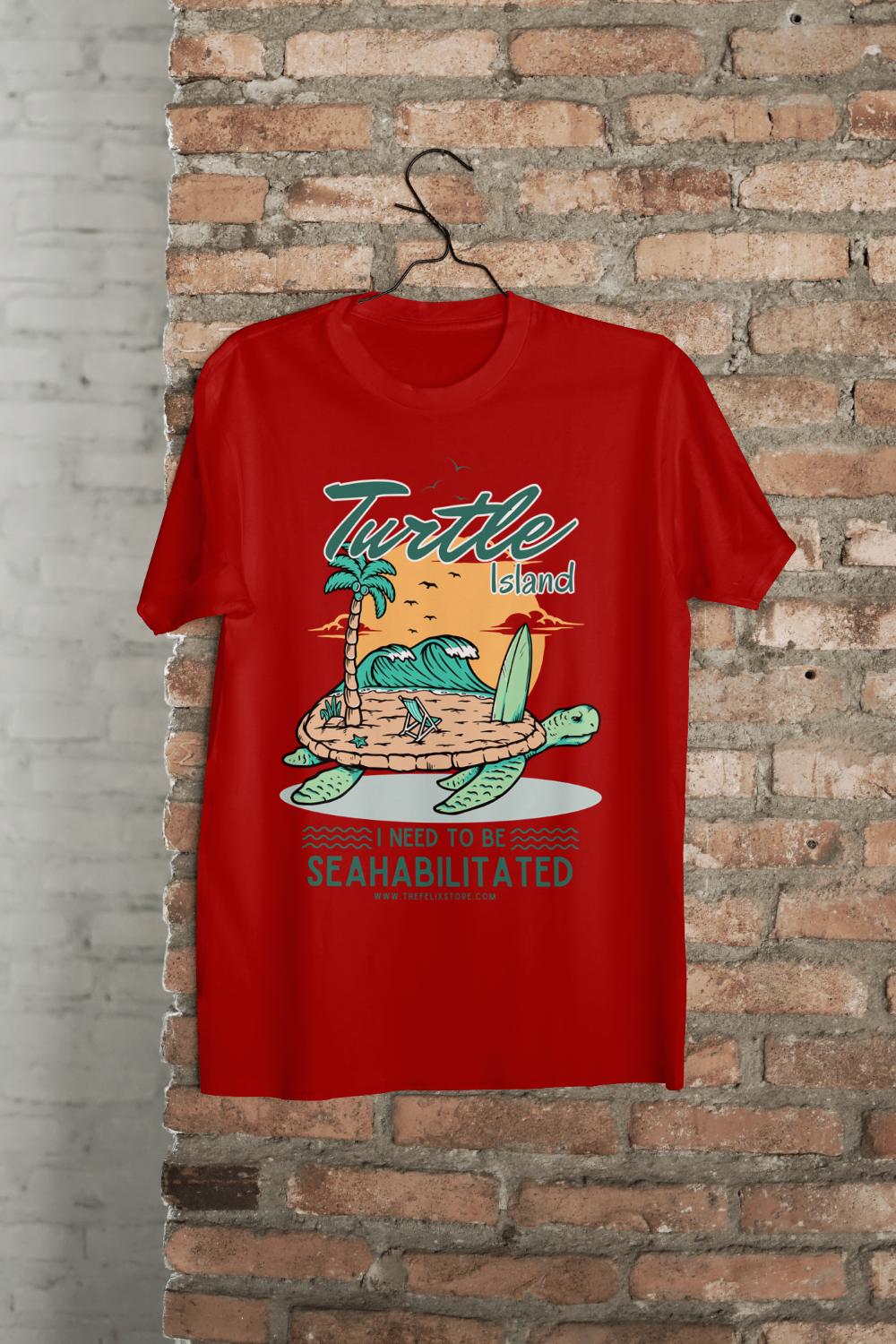 t-shirt featuring a colorful turtle carrying a tropical island with the phrase “I Need to Be Seahabilitated” 